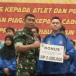 Dandim 0320/Dumai Letkol Hermansyah Tarigan SE menyerahkan bonus kepada atlet Porprov X Riau. F : HMSKODIM